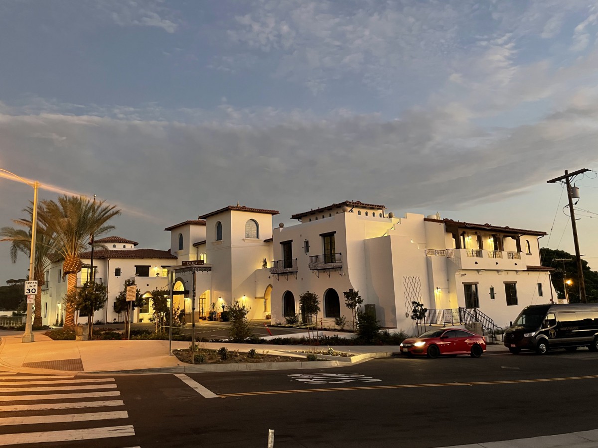 A scenic view of a Mediterranean-style building illuminated in the evening light.