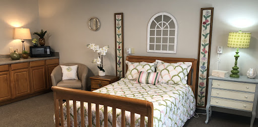 A cozy and inviting bedroom featuring a wooden bed, stylish bedding, and elegant wall decor.