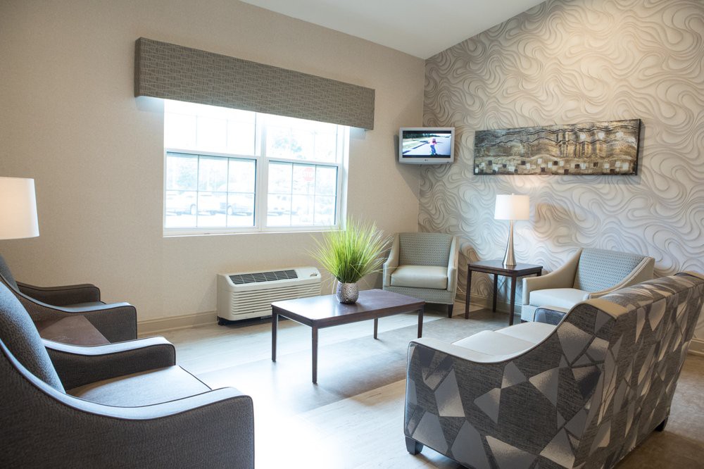 A modern living room with ample seating, natural light, and stylish decor.