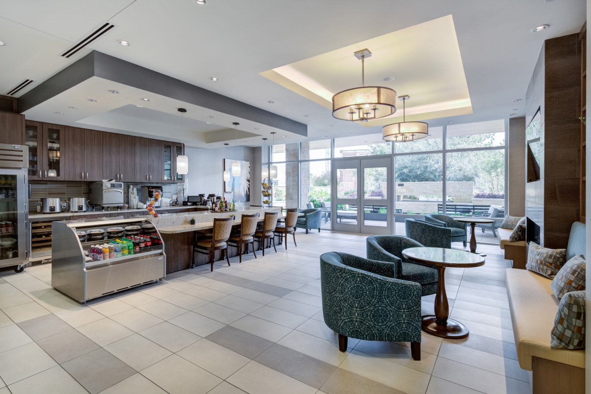 A modern cafe interior with seating area and counter.