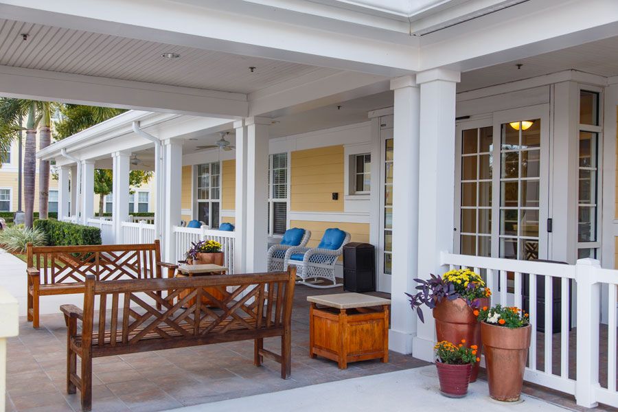A welcoming porch with comfortable seating and vibrant flowers.