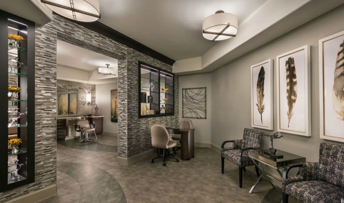A modern waiting area with stylish seating, artwork, and contemporary lighting.