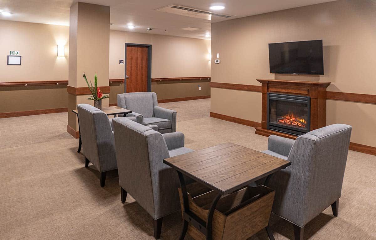 Cozy lounge area with modern seating and a fireplace.