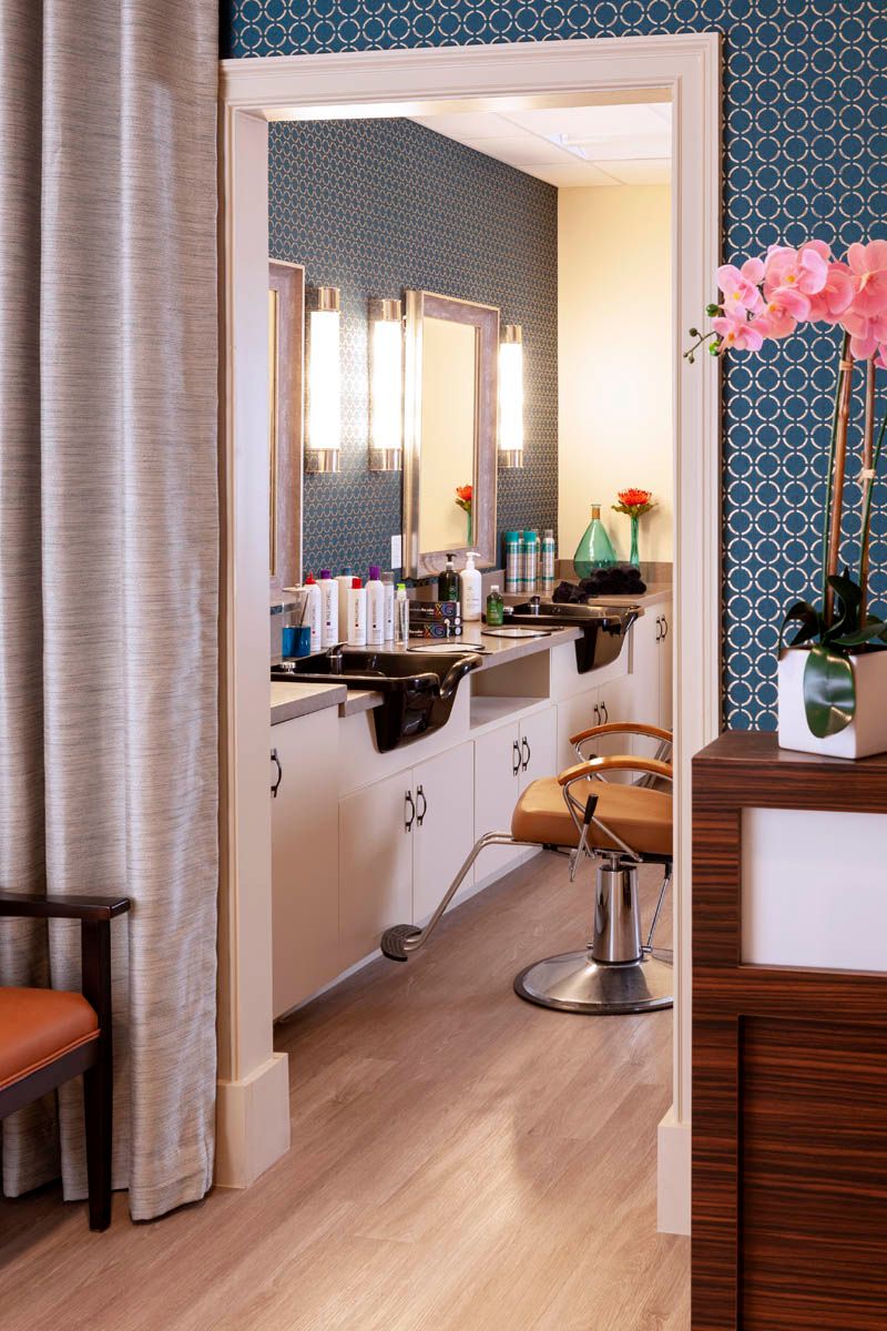 A stylish and modern hair salon with comfortable chairs and a range of beauty products.