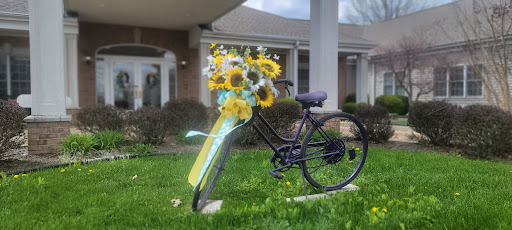 A charming bicycle adorned with a vibrant bouquet of sunflowers, bringing a touch of spring to the outdoor scene.