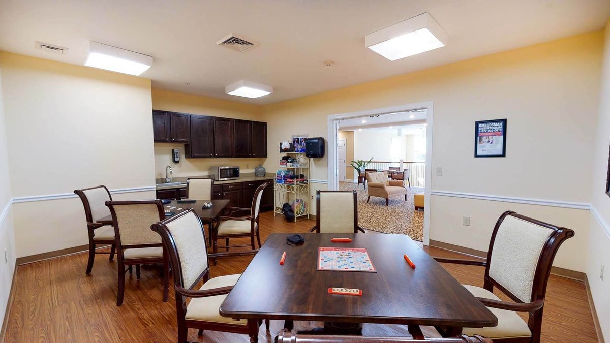 A cozy kitchen and dining area with wooden floors and comfortable seating.