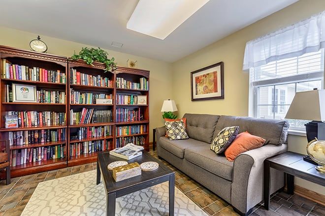 A cozy living room with a well-stocked bookshelf, comfortable sofa, and tasteful decor.