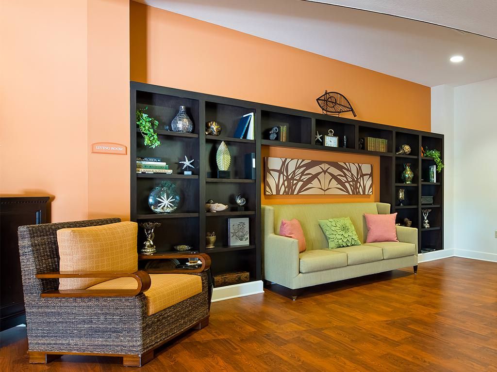 A modern living room with a comfortable sofa and decorative shelves.