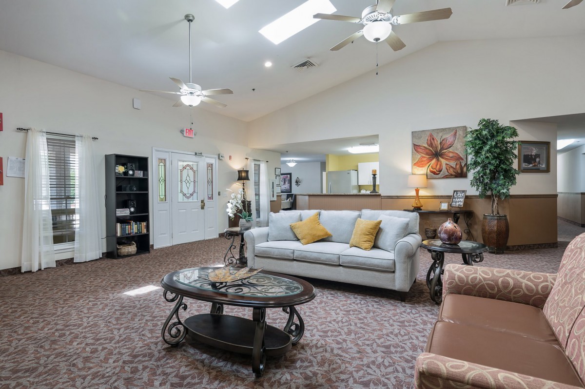 A spacious and well-lit living room with comfortable seating and elegant decor.