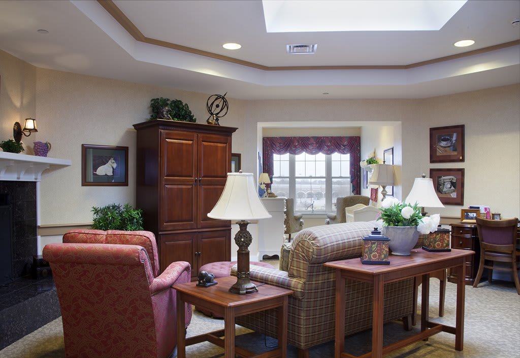 A cozy living room with comfortable seating, decorative elements, and natural light.