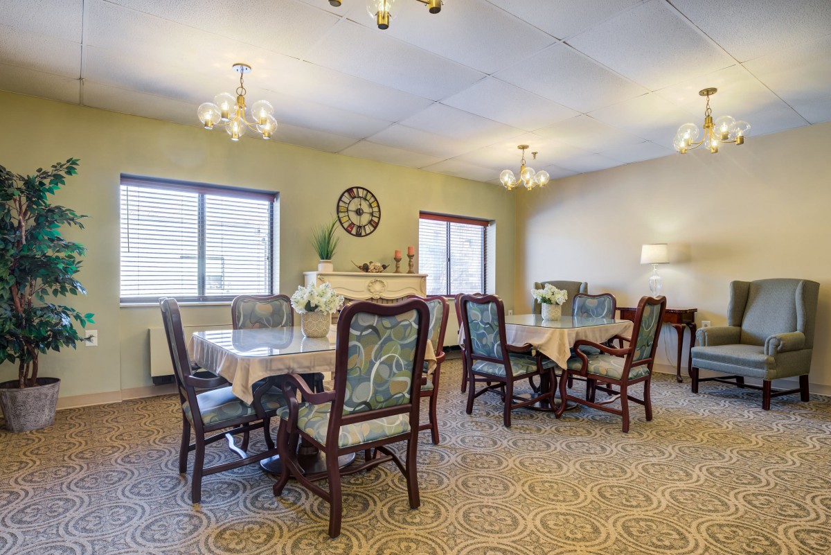 A spacious dining room with elegant furniture and decorative elements.