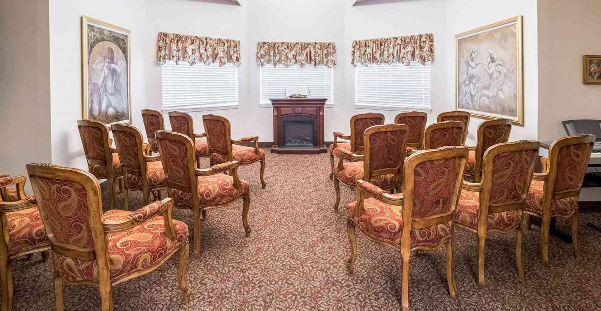 A small conference room with upholstered chairs and a decorative carpet.