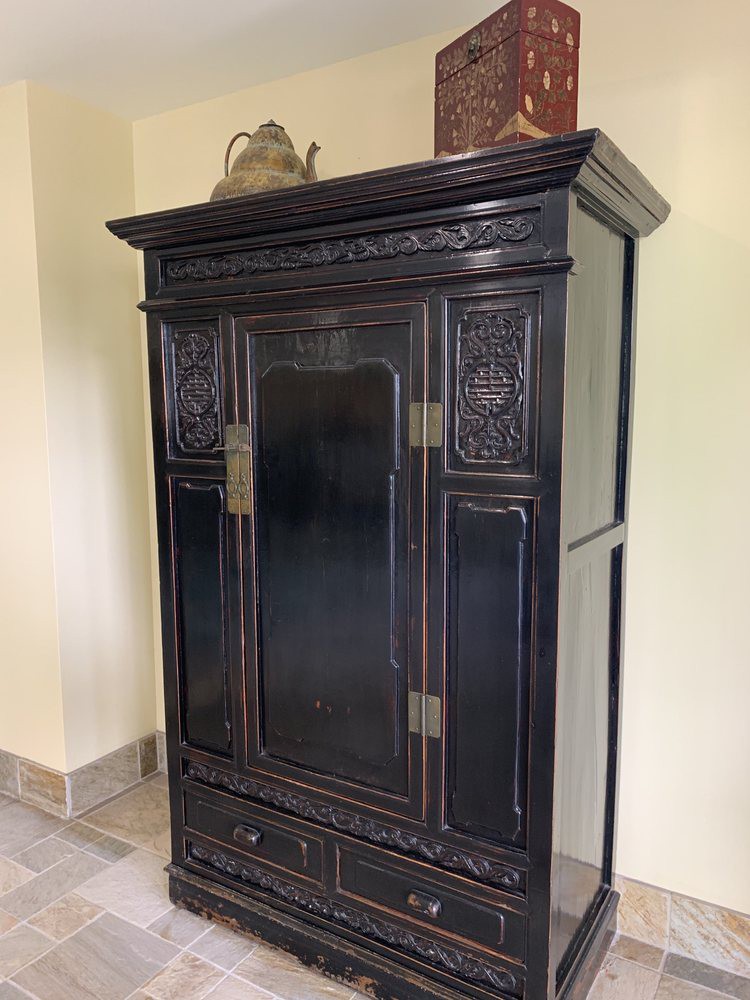 An antique wooden cabinet with intricate carvings.