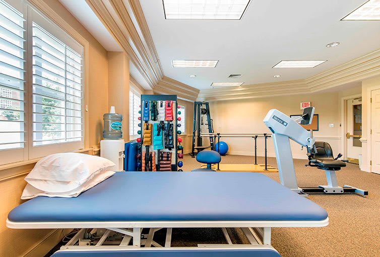 A well-equipped physical therapy room with various exercise and rehabilitation tools.
