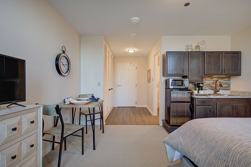 Modern studio apartment with a compact kitchenette and tasteful decor.
