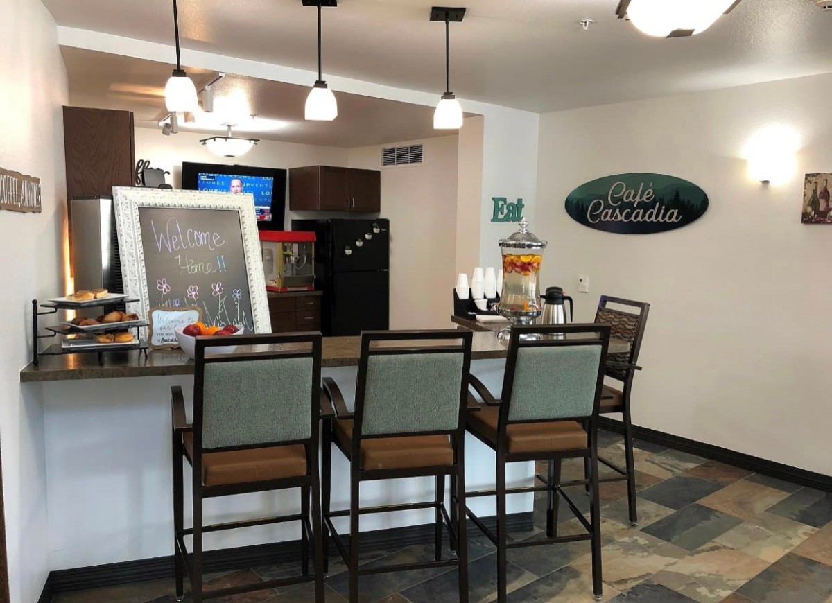 An inviting bar area with high chairs and cozy lighting, perfect for a casual hangout.