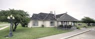 A suburban residential house with a front lawn.
