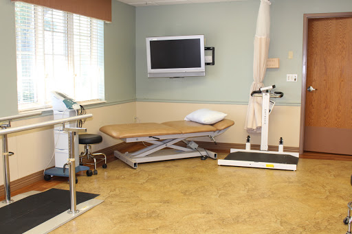 A clean and organized treatment room equipped for physical therapy.