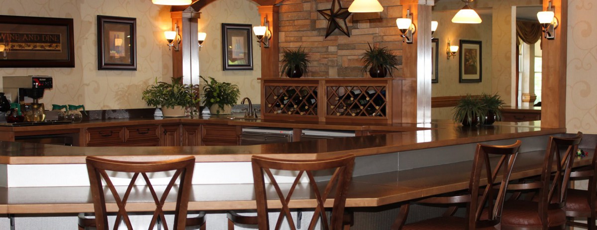 A cozy restaurant interior featuring wooden furniture and a wine rack.
