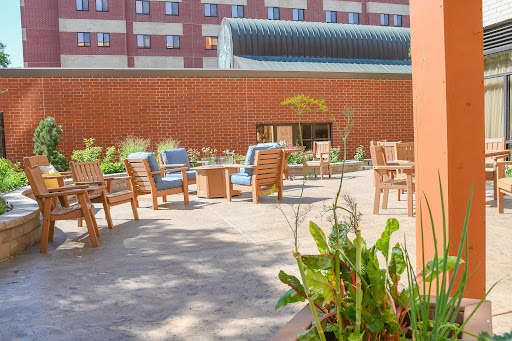 A cozy outdoor seating area surrounded by greenery, perfect for relaxation.