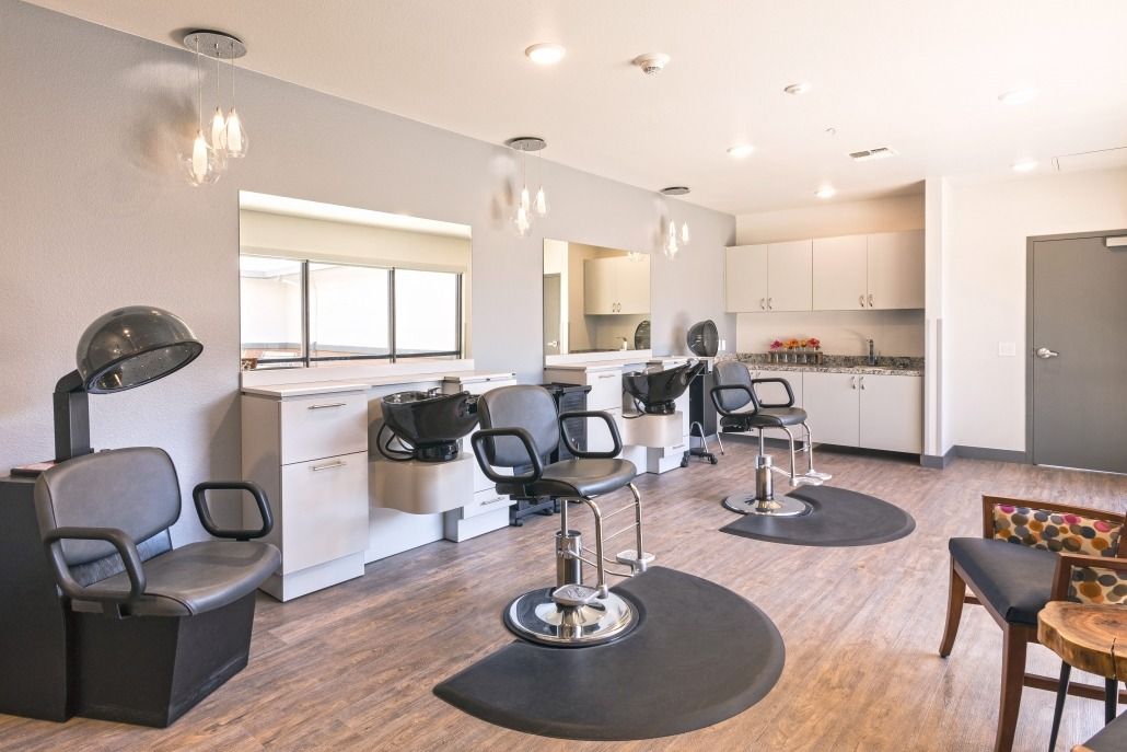 A modern hair salon interior with styling stations and chairs.
