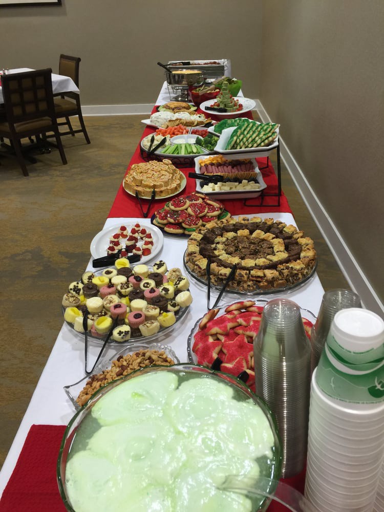 A buffet table with a variety of desserts and sweets arranged for an event.