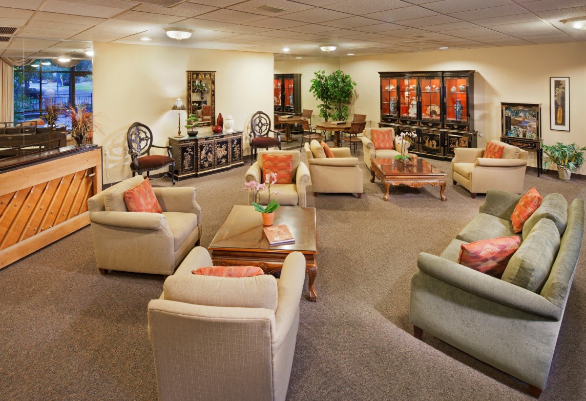 A spacious and elegantly decorated lounge area with comfortable seating and warm lighting.