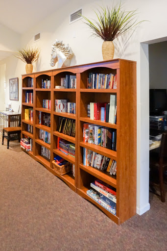 A well-organized wooden bookshelf filled with various books, adding a cozy touch to the living room.