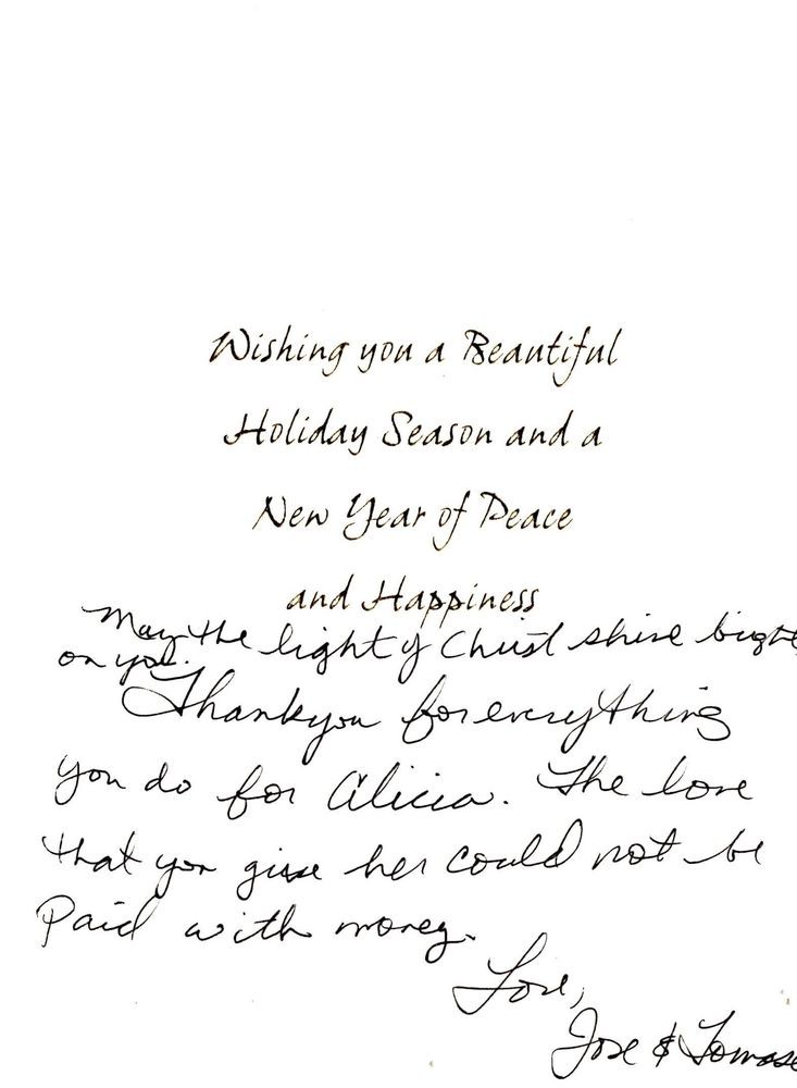 A holiday greeting card with a printed message and a handwritten note, wishing peace and happiness for the New Year.