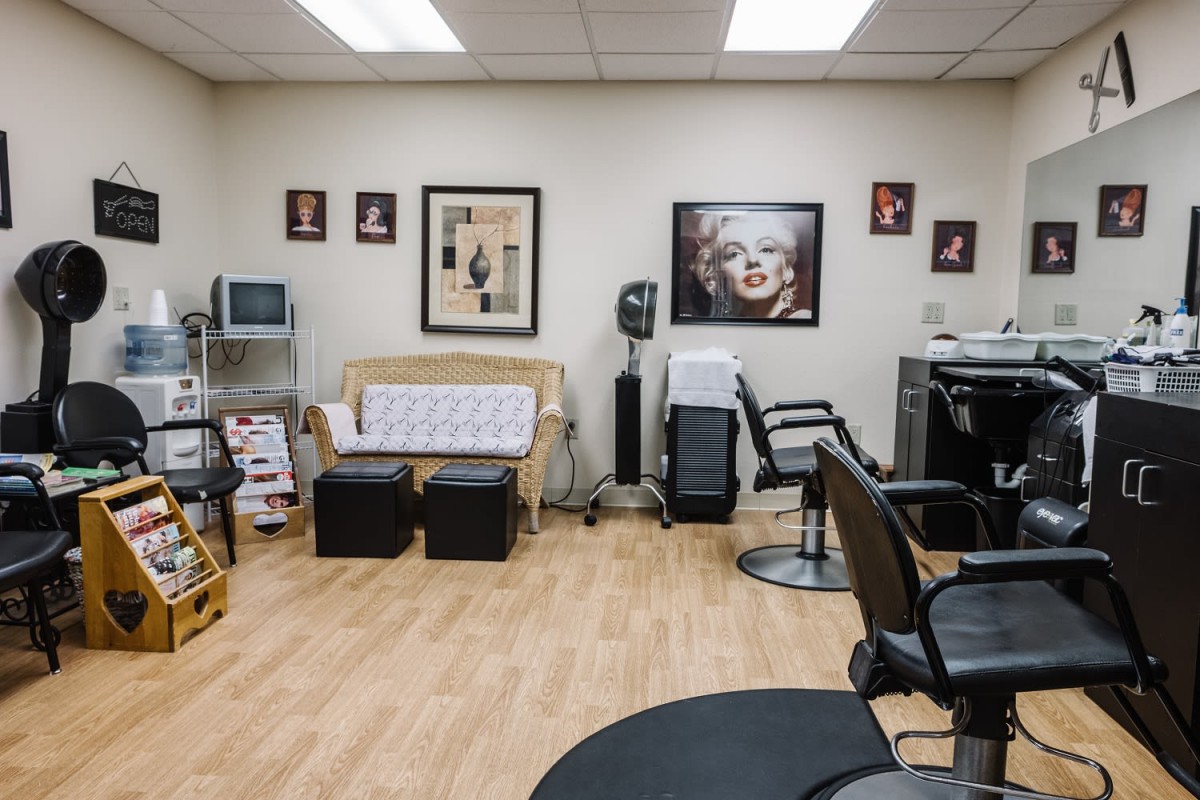 A well-organized hair salon interior with chairs, mirrors, and beauty equipment.