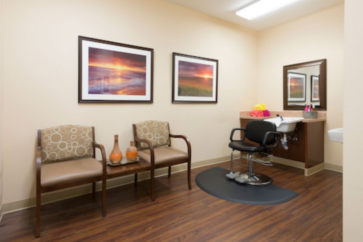 A well-decorated waiting room with cozy seating and scenic artwork on the walls.