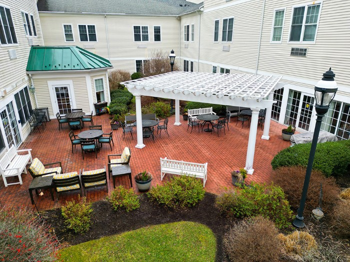 A view of a courtyard with outdoor seating and a pergola.