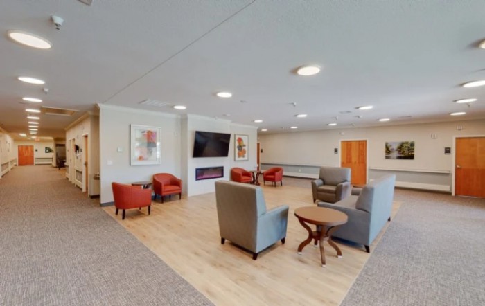 A modern lobby with comfortable seating and a television.