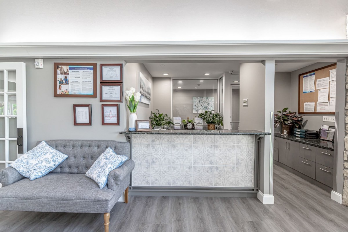 Modern office reception area with seating and decor.