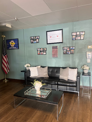 A welcoming lobby space featuring modern seating, decorative flags, and framed photographs.