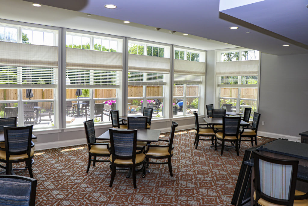 A modern dining area with large windows allowing natural light to fill the room.