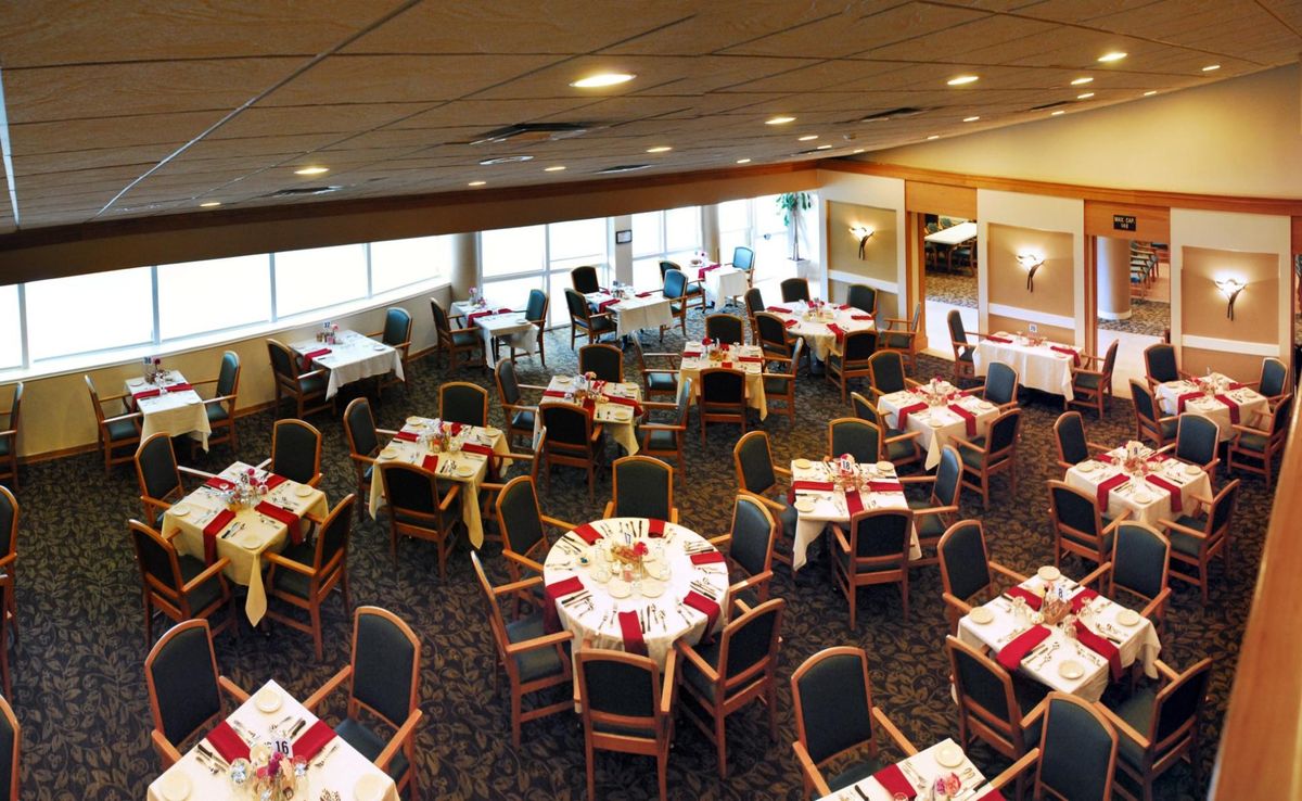 An elegant dining area with tables set for an event.