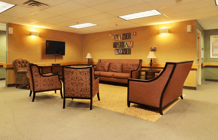 Comfortable seating area with a sofa, chairs, and a television.