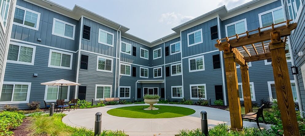 A modern apartment building with a landscaped courtyard.