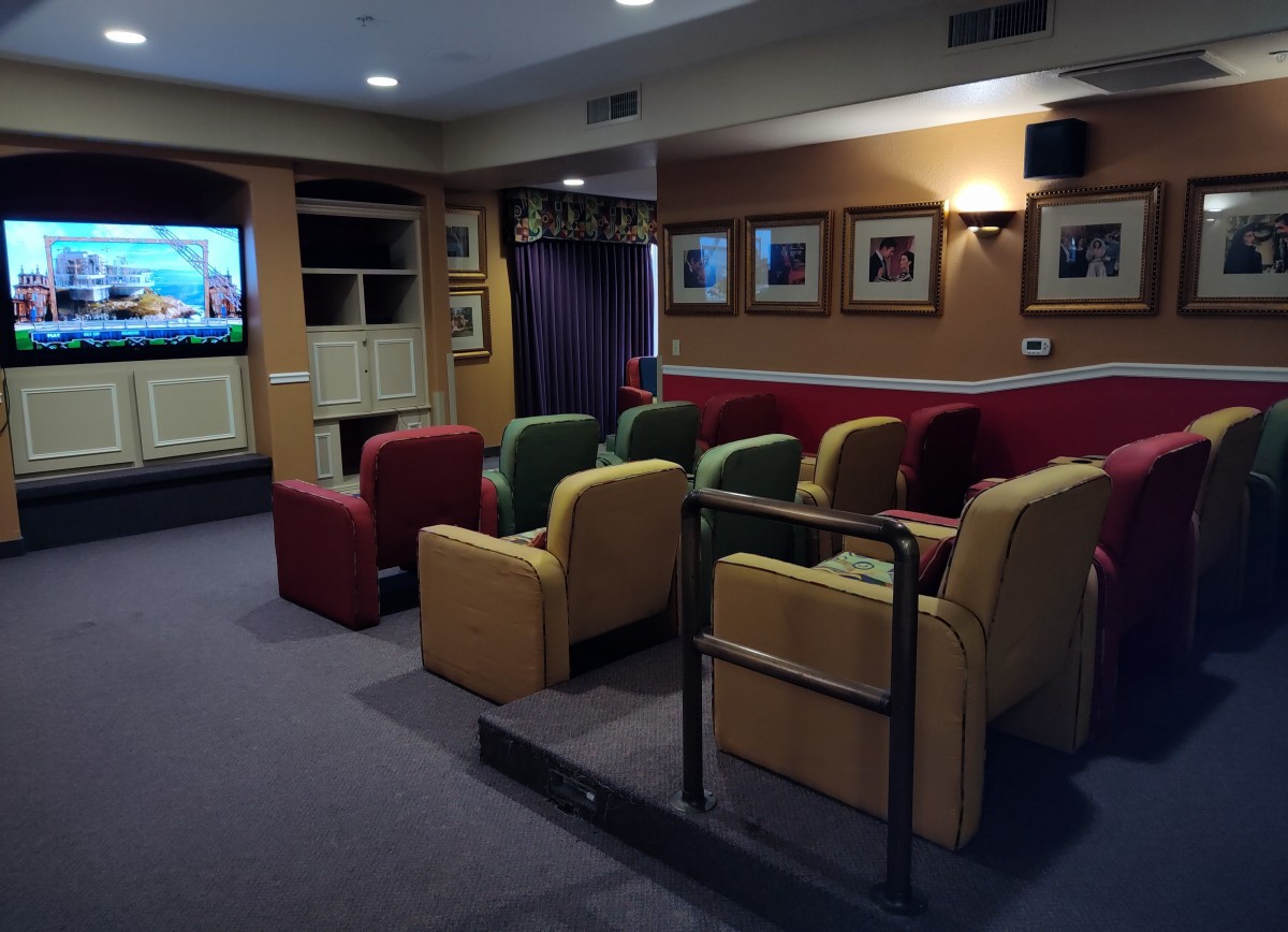 Cozy home theater room with comfortable seating and a large screen.