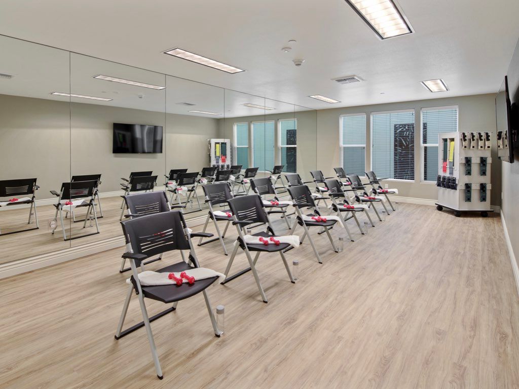 A modern training room setup with rows of chairs and tables, ready for a presentation or class.