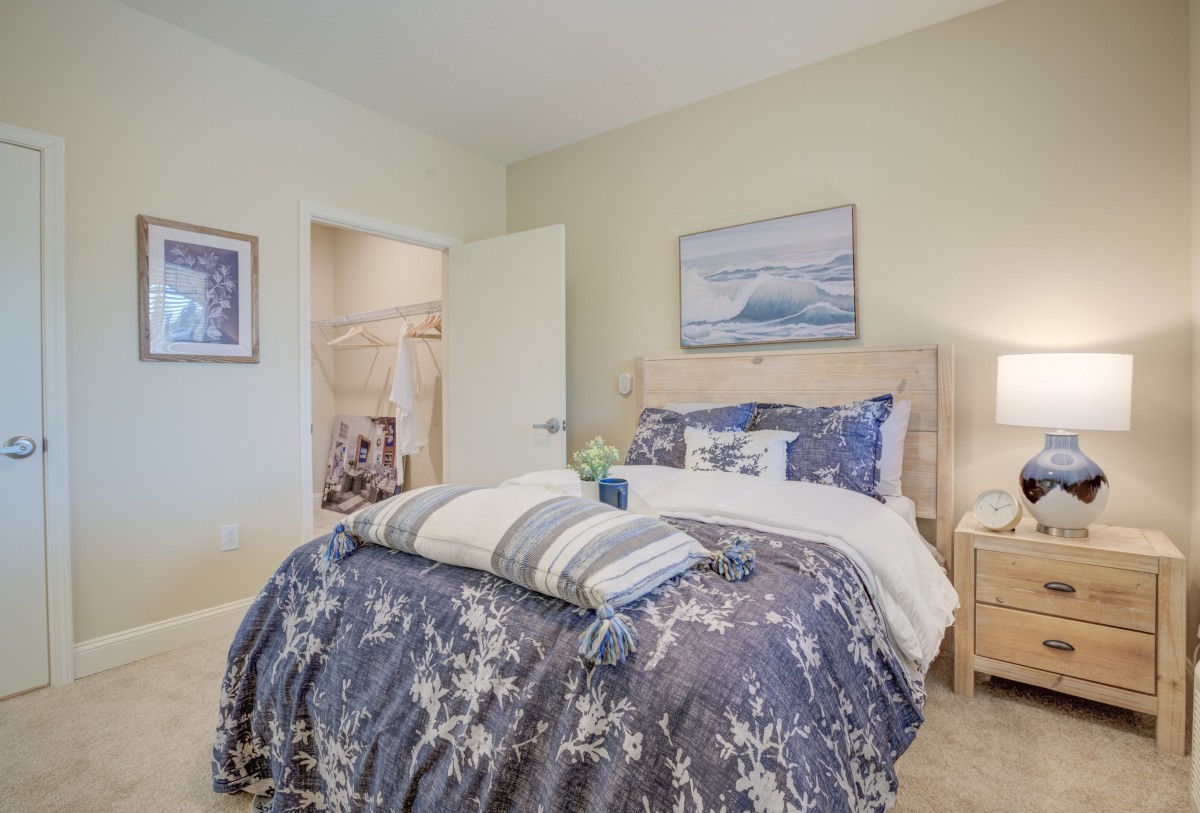 A cozy bedroom interior with a neatly made bed and calming decor.