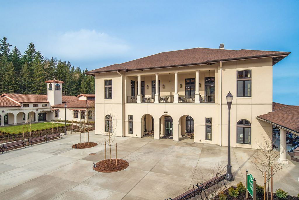 A large building with a courtyard, featuring columns and a balcony.