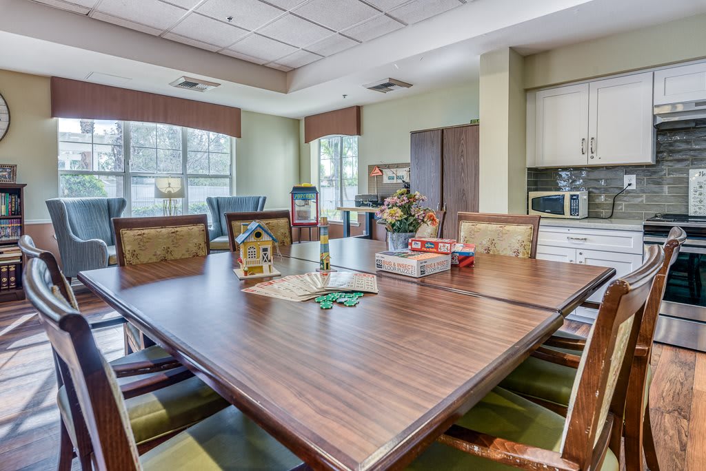 A well-lit conference room with a large meeting table and comfortable chairs.