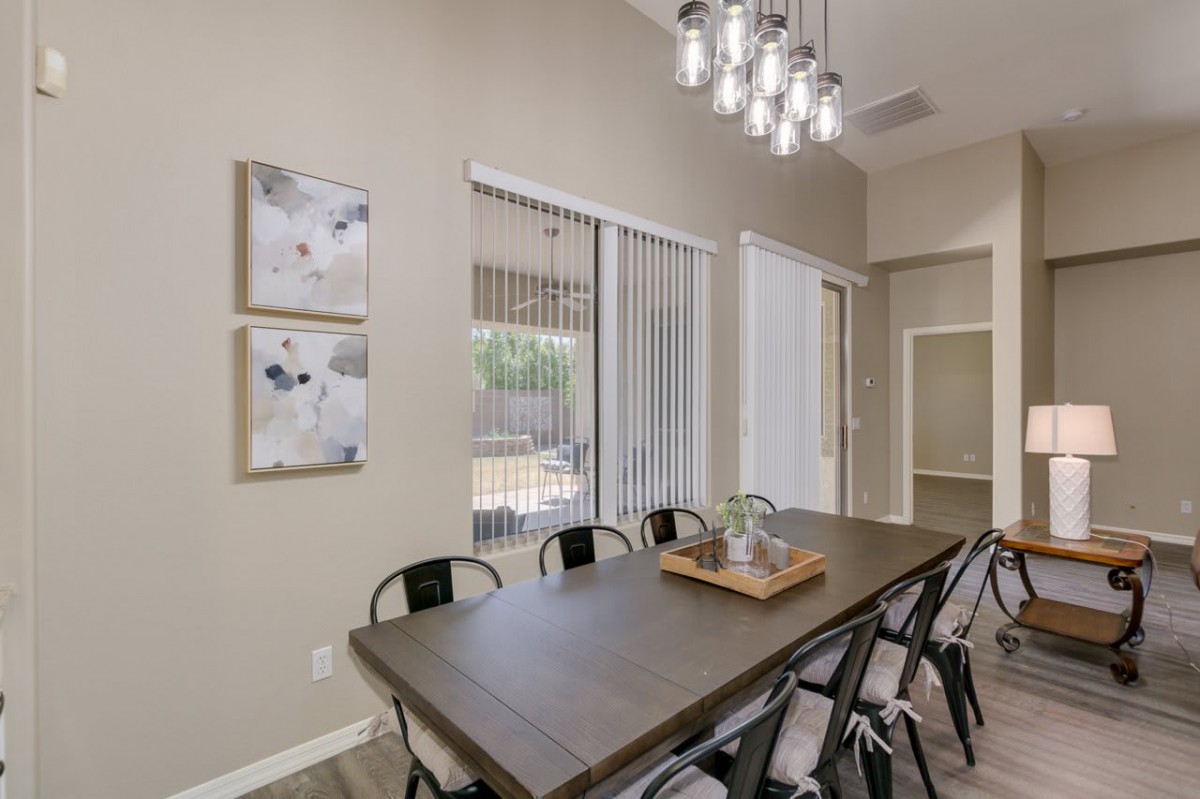 A modern dining room with a large table and contemporary lighting.