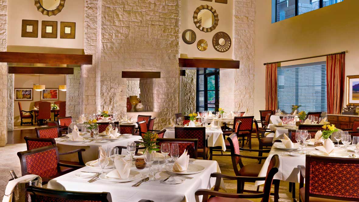 A beautifully decorated restaurant interior with elegantly set tables, ready for fine dining.