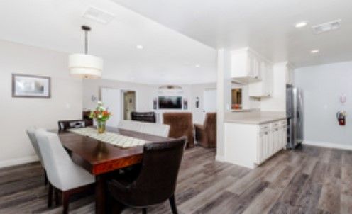 A modern open-concept dining and kitchen area with sleek furnishings and contemporary decor.