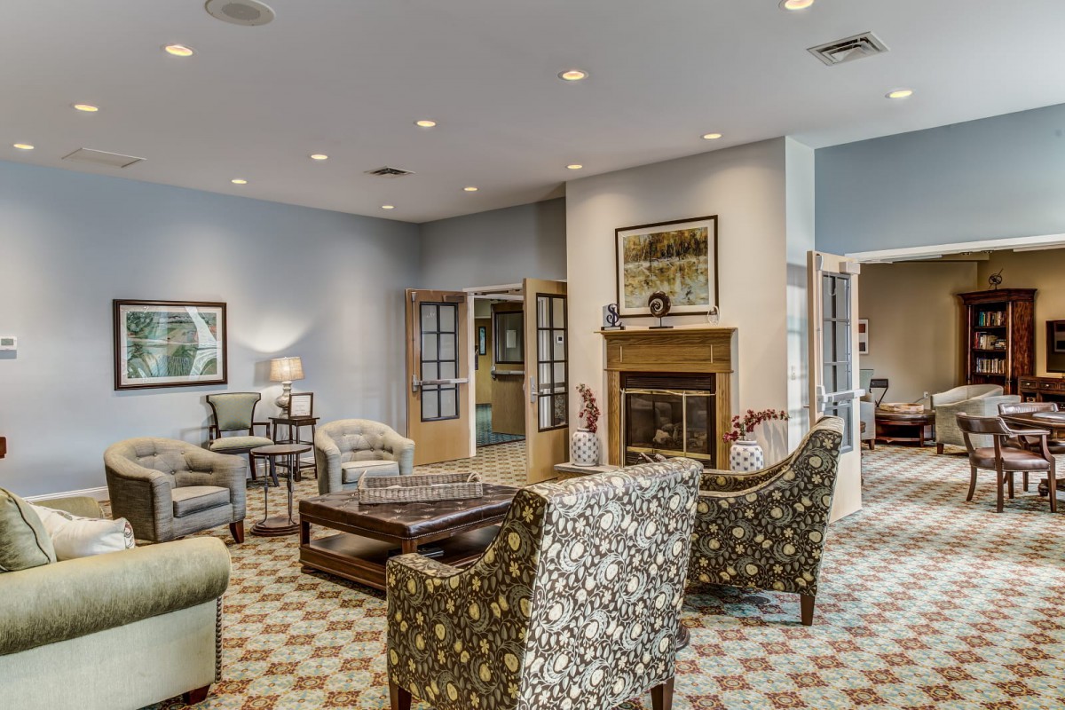 A cozy living room with elegant furniture, a fireplace, and stylish decor.