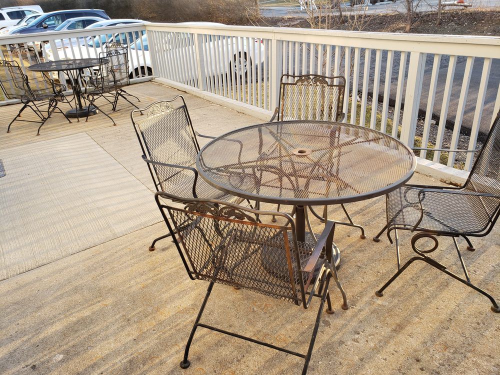 Outdoor metal patio furniture on a wooden deck