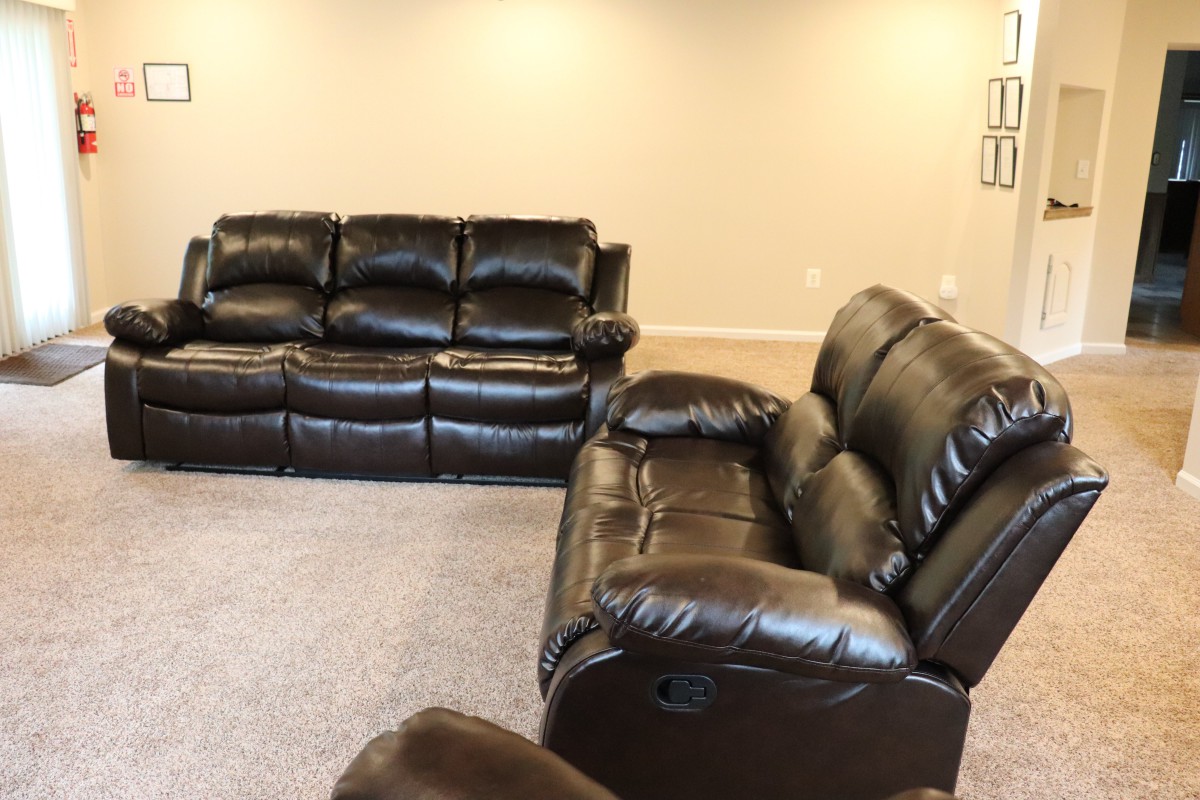 A living room featuring leather sofas arranged for comfortable seating.